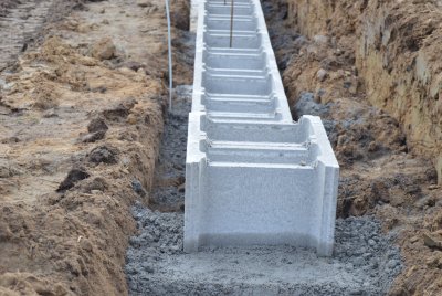 Pro zhotovení základů se často používají betonové šalovací tvarovky, které se pokládají do vrstvy betonu. Tvarovky se následně vyplňují betonem.